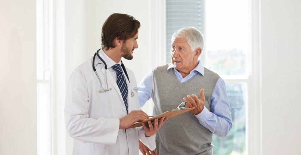 Doctor helping an elderly patient