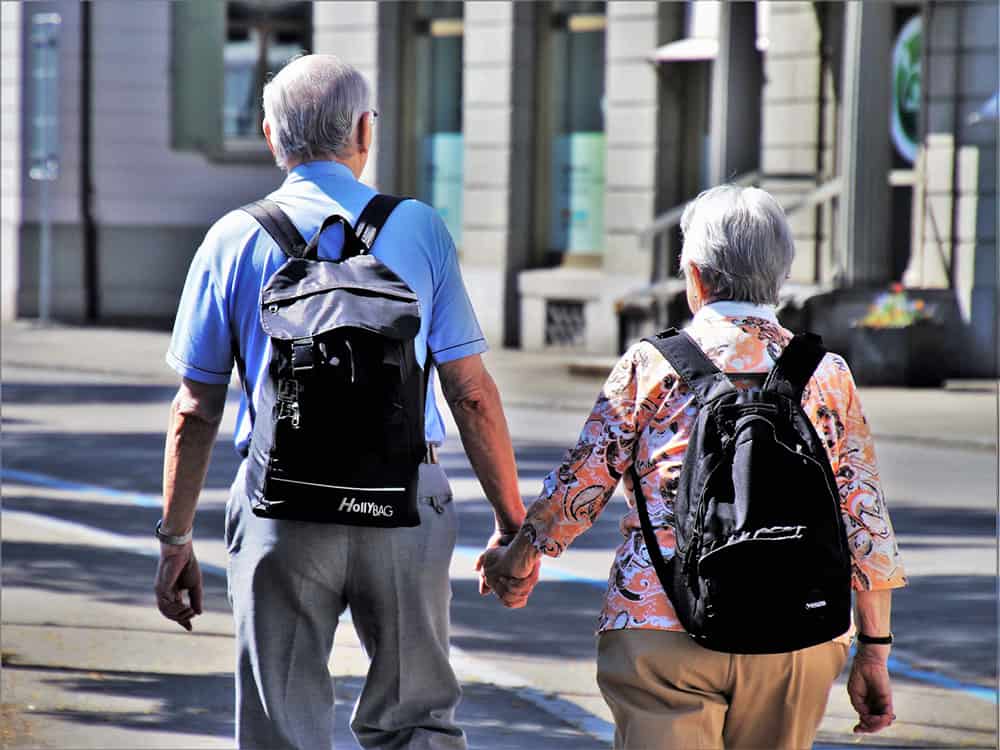 elderly couple holding hands image