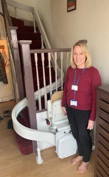 Kerry Wloskowicz, of the Harrow Community Palliative Care Team, is pictured with the newly installed stairlift in Tixie’s home image