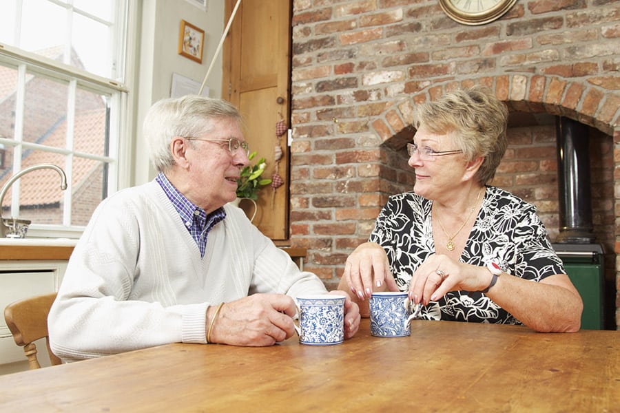Elderly couple having a coffee image