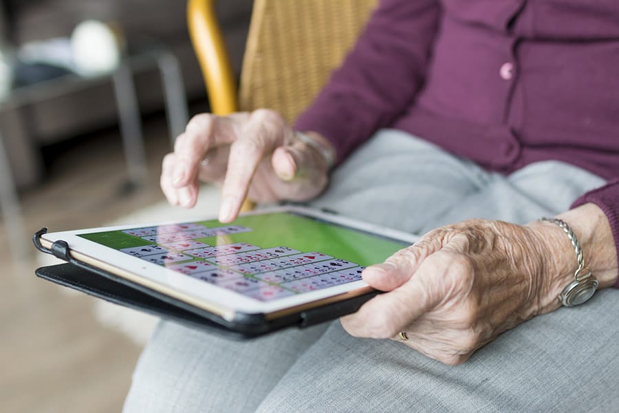 elderly woman using tablet image