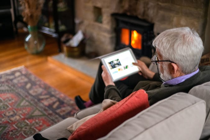 Elderly man using tablet image