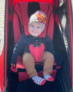 Child in a red YOGI stroller.